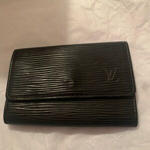 Black Louis Vuitton 6 ring keyholder . Small rub in upper left side.
